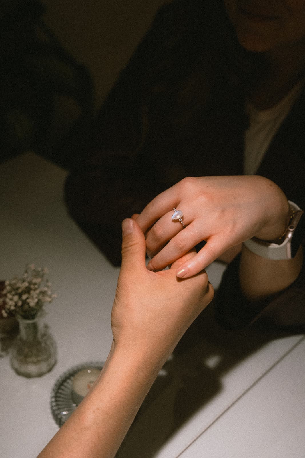 Timothée Volpi and Vanda Gregušová holding hands, with the engagement ring
